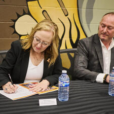 Two leaders signing the new enhancement agreement